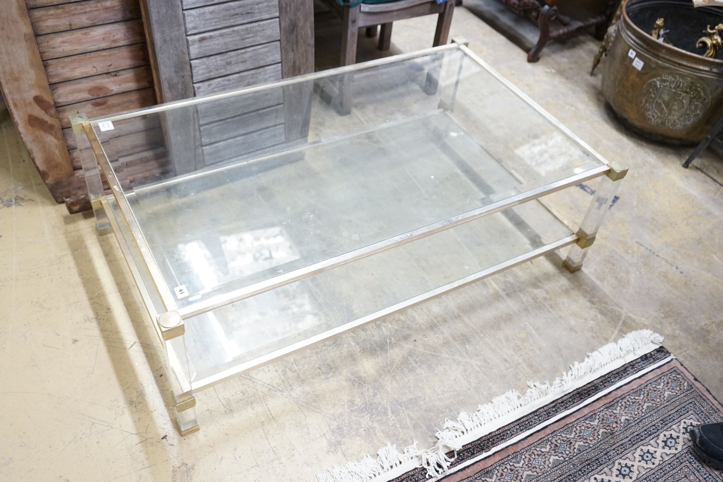 A contemporary metal and bevelled glass two tier coffee table, width 128cm, depth 77cm, height 40cm